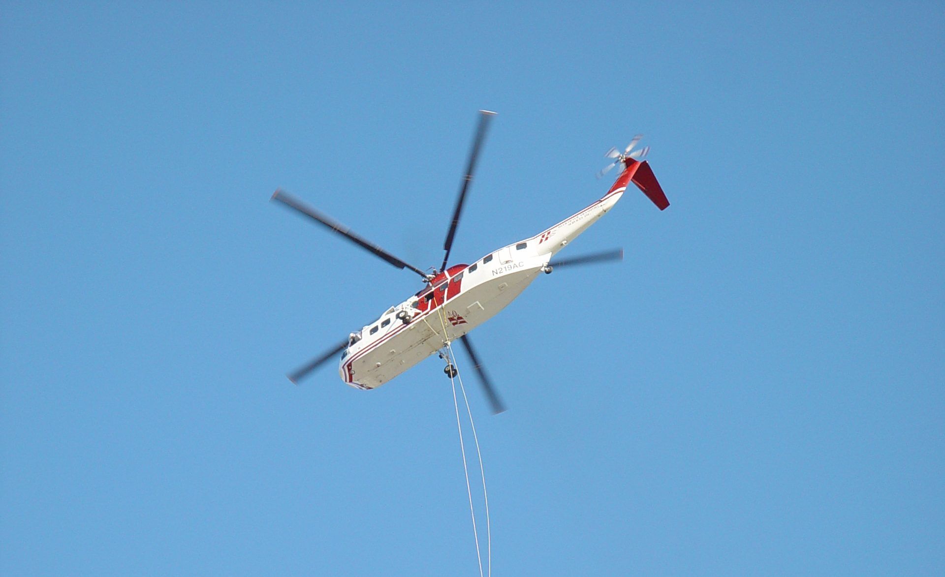 Skycrane carrying a load on a long line
