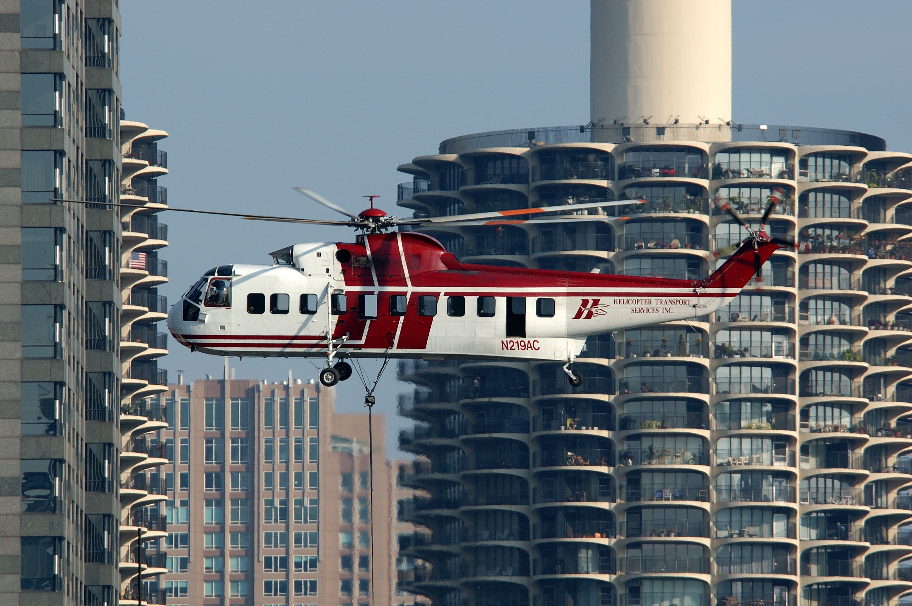 S-61N hovering between residential towers during a city lift