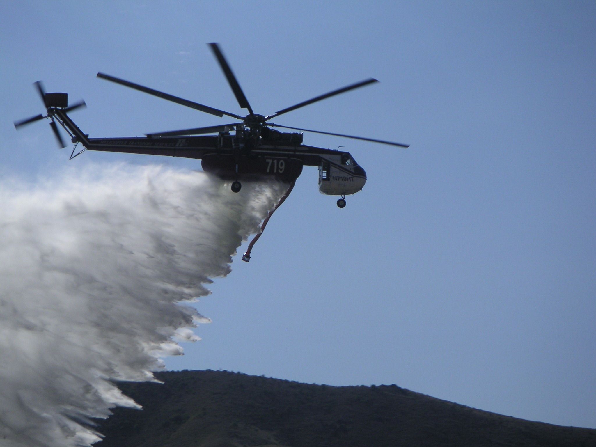 Skycrane dropping water above a ridge