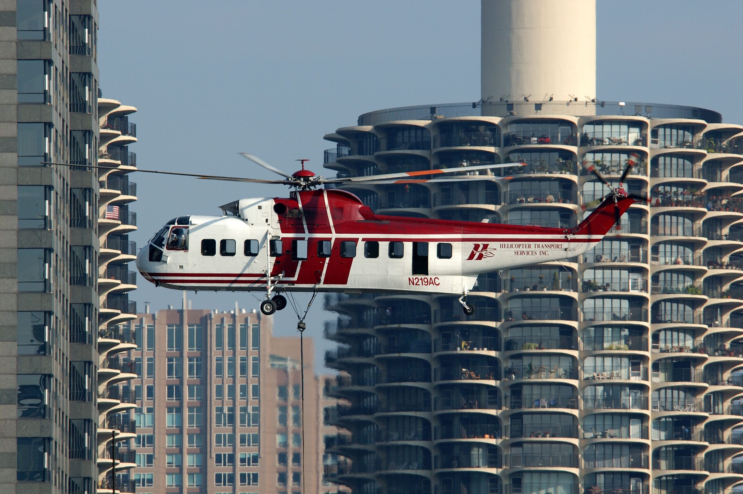 HTS S-61N hovering between residential towers during a city lift