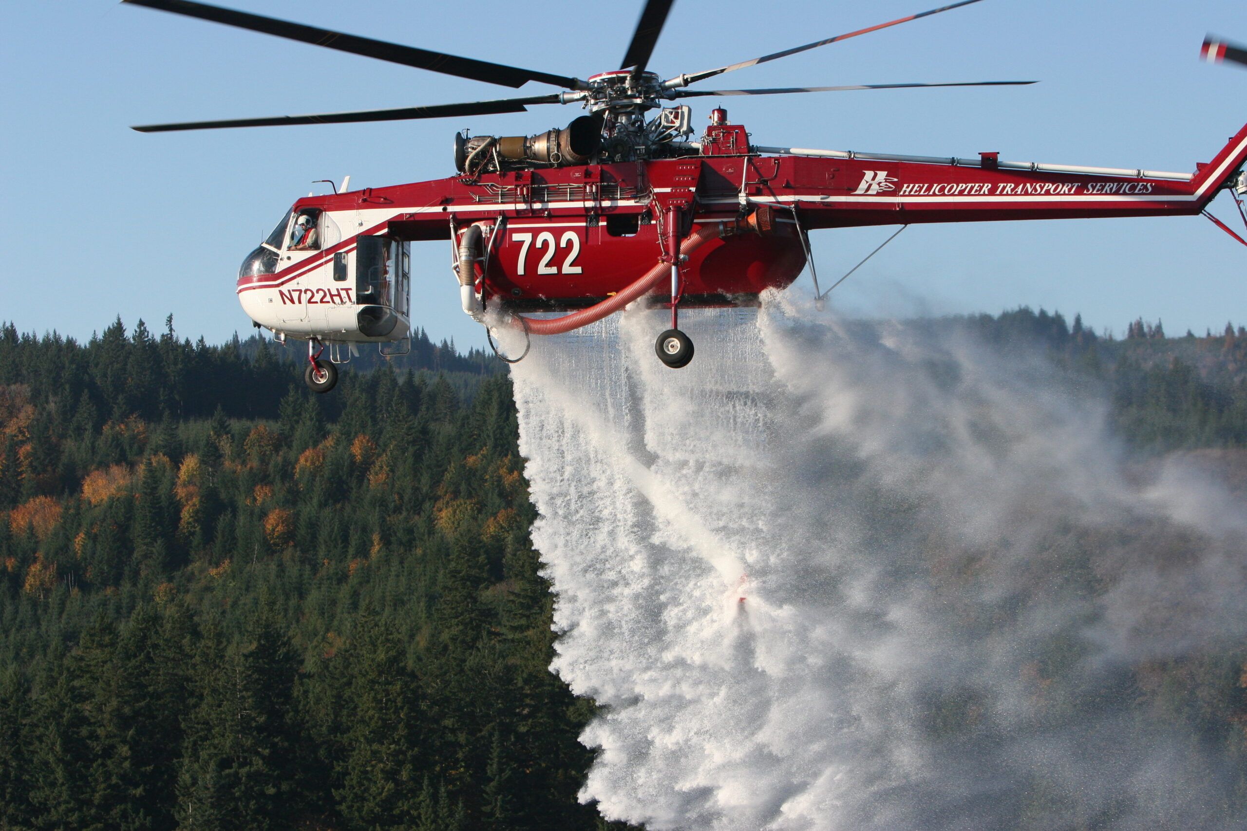 HTS CH-54B Skycrane 722 releasing a water drop over forest