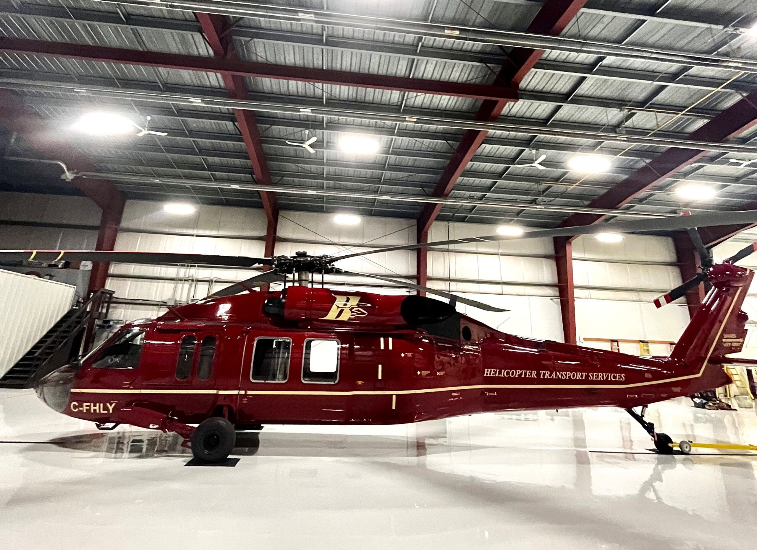HTS Black Hawk C-FHLY parked inside a bright hangar