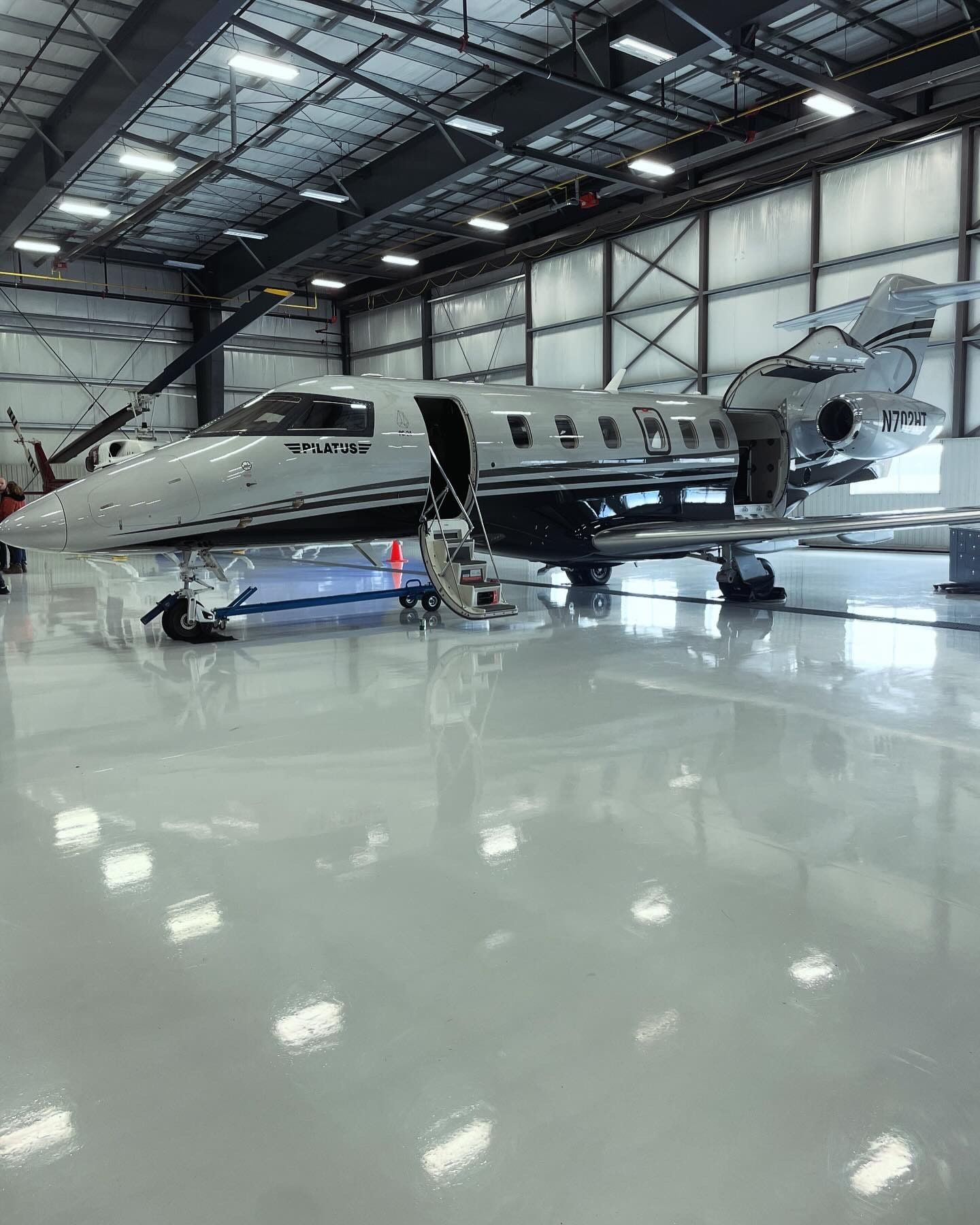 The Pilatus PC-24 on a polished hangar floor, airstair down